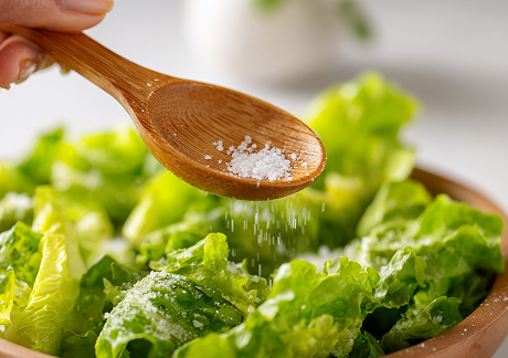 plat24941_a_person_holding_a_wooden_spoon_filled_with_salt_over_fb4c6f83-8574-4a4b-8c2f-8b3d5fbf7cad 1.jpg